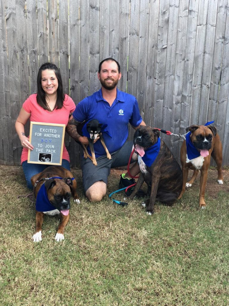 Alicia, Brady, and their dogs with ultrasound announcement